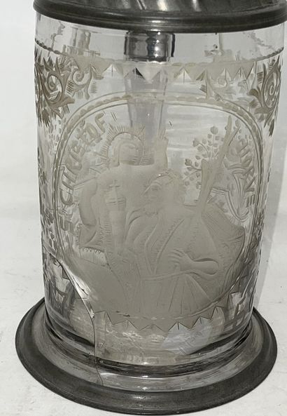 null 
Lot of two mugs including:

- engraved glass mug "Saint Christof Horve", dated...