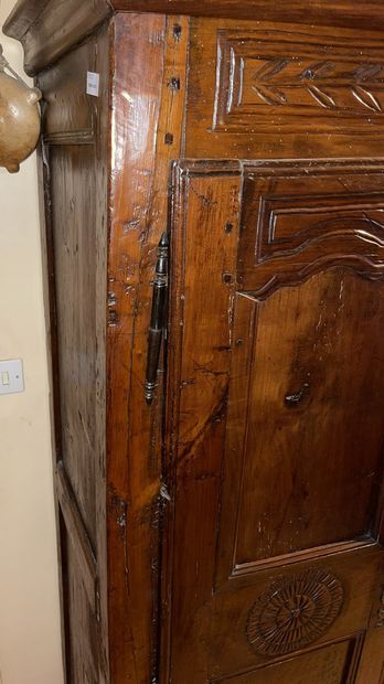 null Natural wood cupboard molded and carved with rosettes, opening with two doors

19th...