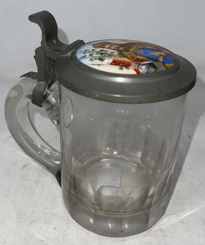 null 
Lot of two mugs including:




- cut glass mug, pewter lid decorated with a...