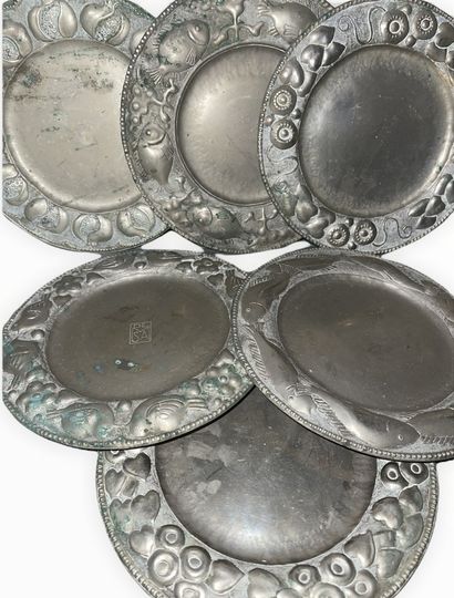null Suite of six metal dessert plates with different repoussé decorations, marked...
