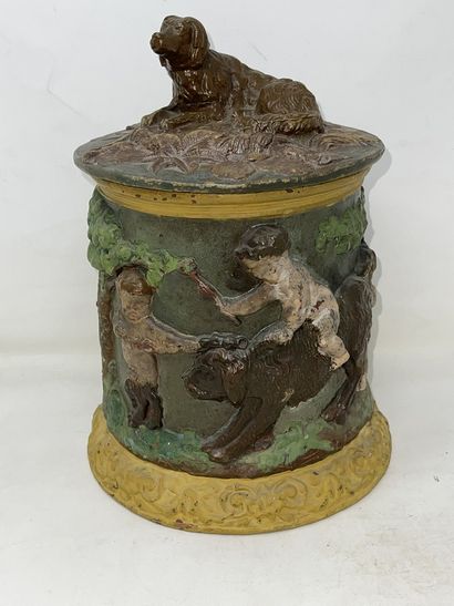 null Tobacco pot in glazed earth decorated with cherubs on dogs, fretel in the shape...