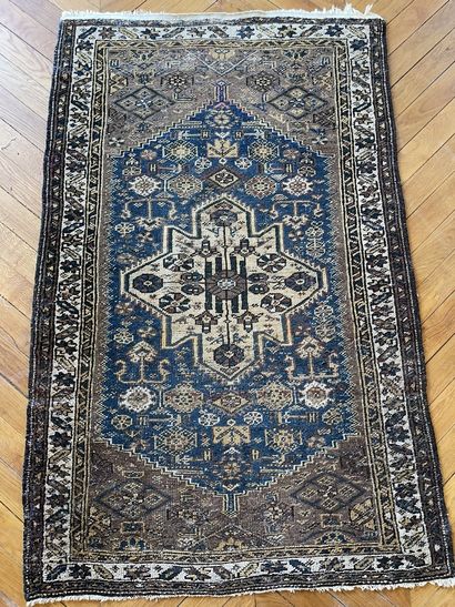 null 
Wool carpet, Caucasus, decorated with a central medallion beige on blue background,...