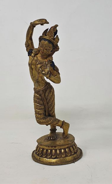 null Gilded bronze and colored statue of Maya Devi dancing, double vajra at the base

Nepal,...