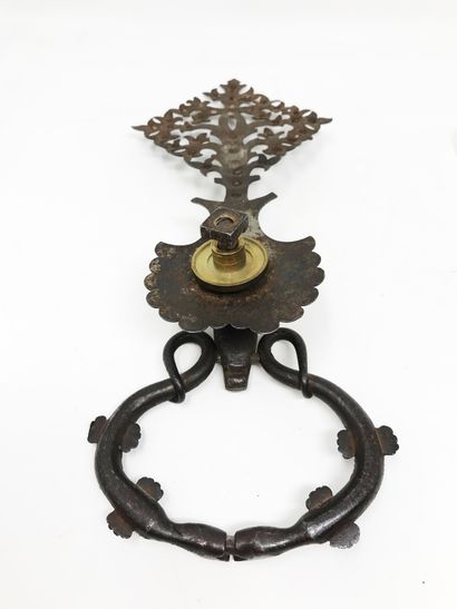 null Doorknocker in wrought iron and carved in head of stag, holding the ring formed...