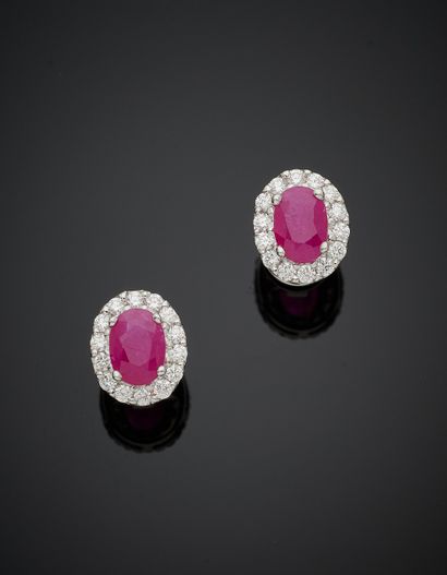 null Pair of white gold (750‰) oval EARRINGS set with a ruby weighing 1.11 carats...