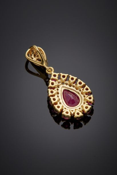 null Yellow gold (750‰) "drop" pendant set with a pear-shaped ruby, surrounded by...