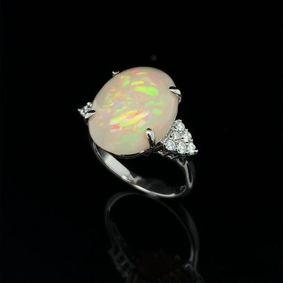 null RING in white gold (750‰) adorned with a cabochon opal, shouldered by twelve...
