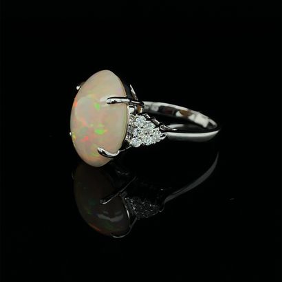 null RING in white gold (750‰) adorned with a cabochon opal, shouldered by twelve...