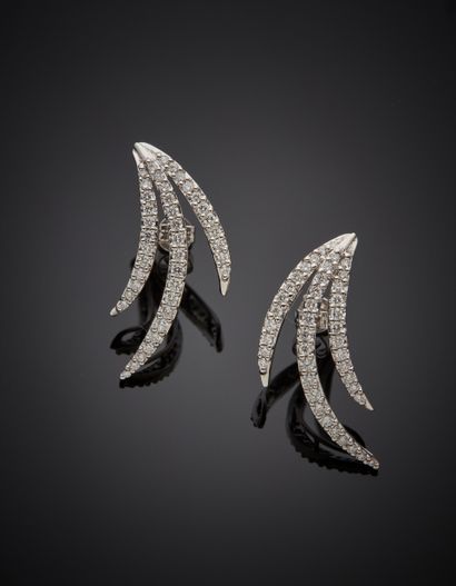 null Pair of "flame" EARRINGS in white gold (750‰) set with three alignments of brilliant-cut...