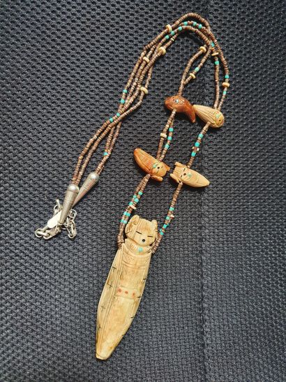 null PENDANT in bone and colored beads, featuring toi-face Zuni fetishes inlaid with...