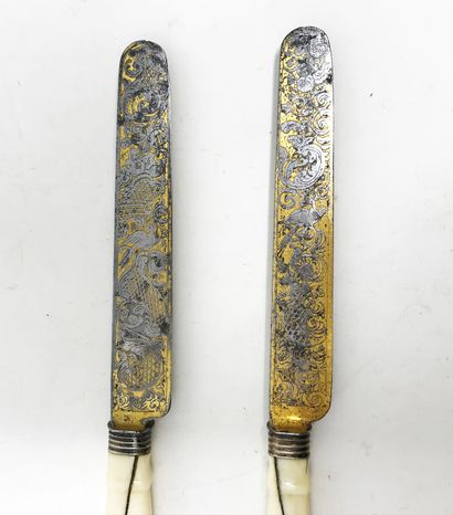 null Two table knives for a couple. Bone handles with engraved and gilded blades,...