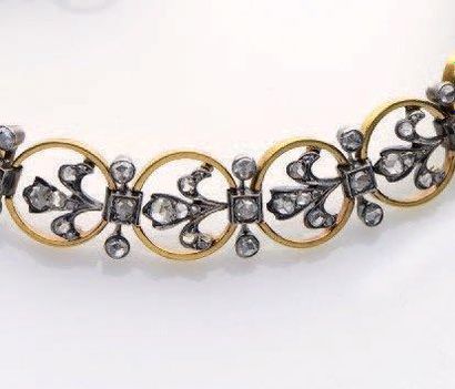 null BRACELET en or jaune (750 millièmes) et argent (925 millièmes) ajouré à motifs...