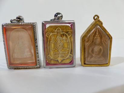 null Set of three amulets: First amulet depicting Buddha sitting in meditation in...