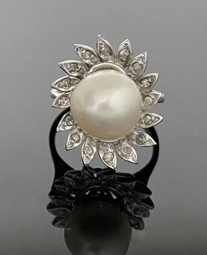null White gold ring set with a large baroque pearl in a poly-lobed setting of small...