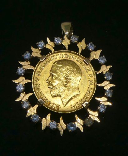 null 
A yellow gold PENDANT with a sovereign in the profile of George V in a setting...