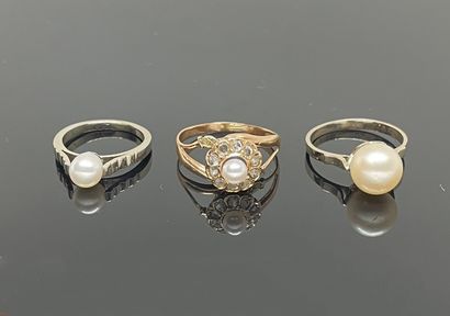null TWO white gold rings and pearls, one yellow gold ring set with a pearl in a...