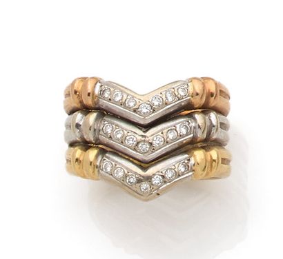 Three gold ring set with a line of small...