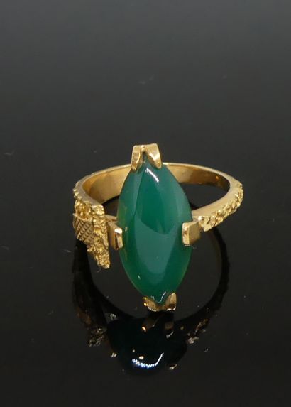 null Gold ring with guilloche, the asymmetrical setting set with a cabochon of chrysoprase....