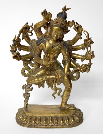 null TIBET. Gilded bronze DIVINITY with eight arms, the body decorated with coloured...