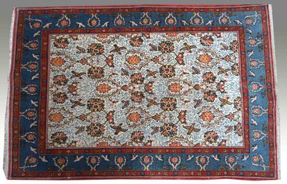 null CARPET with scrolls and birds on an ivory background, blue and red border. 180...
