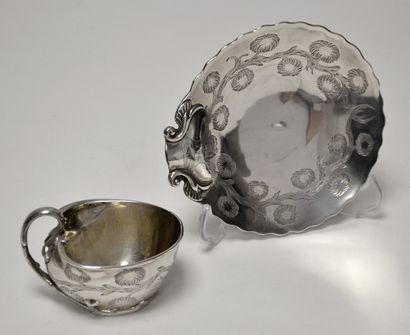 A silver cup and its large saucer, decorated...