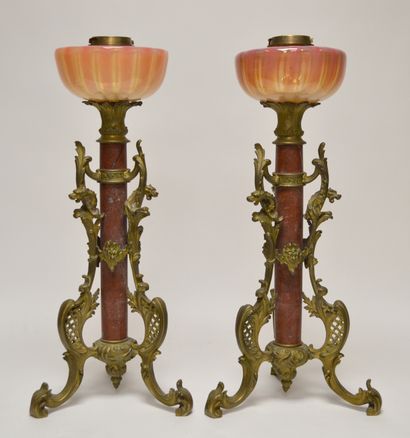  Pair of PETROLEUM LAMPS, the central shaft formed by a red marble cylinder, supported...