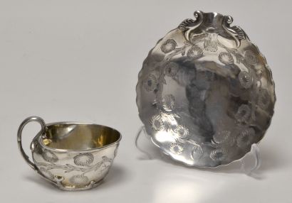  A silver cup and its large saucer, decorated with chrysanthemum flowers and branches,...