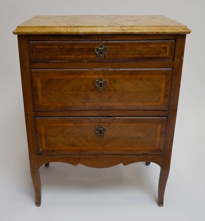null A small rosewood veneered COMMODE, opening with three drawers, the top in yellow...