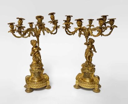 null 
A pair of important ormolu CANDELABRES, the shaft decorated with a putto supporting...