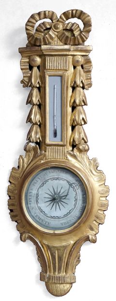 null A carved and gilded wood barometer-thermometer, the circular body with combed...
