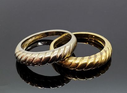 Pair of RINGS, one in yellow gold, the other...