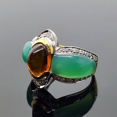 null RING in two golds, set in the center with a cabochon of fine amber stone between...