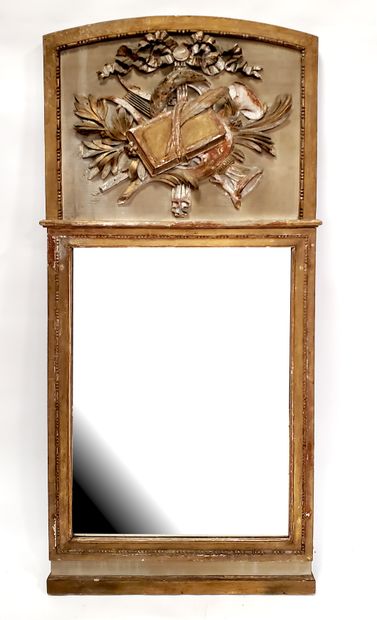 null Trumeau in gilded wood, grey lacquered, topped with a music trophy. Louis XVI...