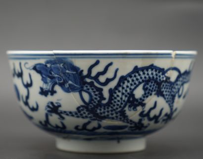 null CHINA. Porcelain bowl decorated in cobalt blue with dragon chasing the sacred...