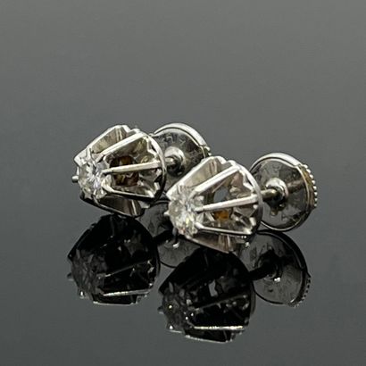 Pair of EARRINGS in 750-mil white gold, claw-set...