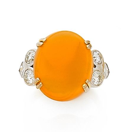 null RING in two 750-mil gold, set with a fire opal cabochon with two brilliant-cut...