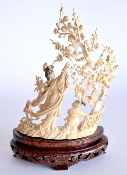null GROUPE en ivoire sculpté et finement repercé, à décor d'une femme et enfant...