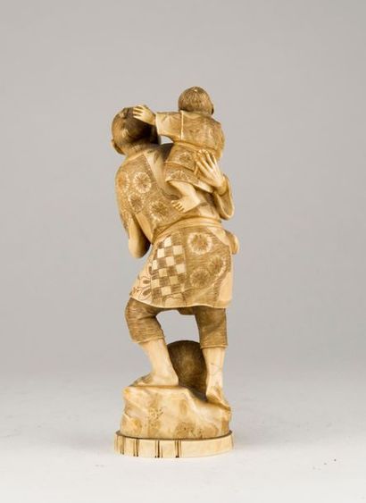 null JAPAN. A farmer carrying a child on his shoulders. Ivory subject carved and...