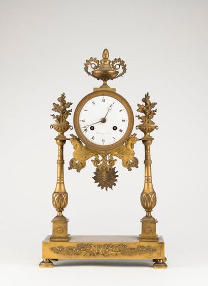 null Portal clock in chased and gilded bronze in neoclassical style, the enamelled...