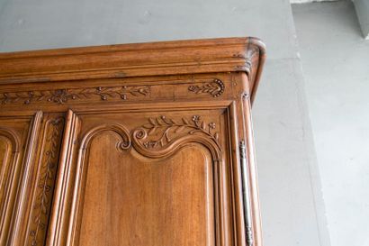null Walnut wardrobe molded and carved with flowers, foliage and stars opening at...