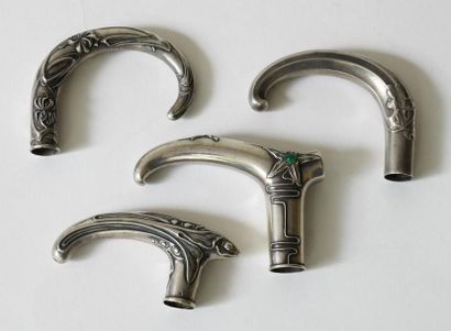 null Set of four hollow and repoussé silver cane pommels, three in Art Nouveau style,...