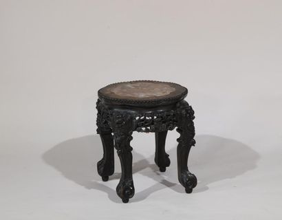 null China or Indochina. 
Carved stool in blackened iron wood, seat with integrated...