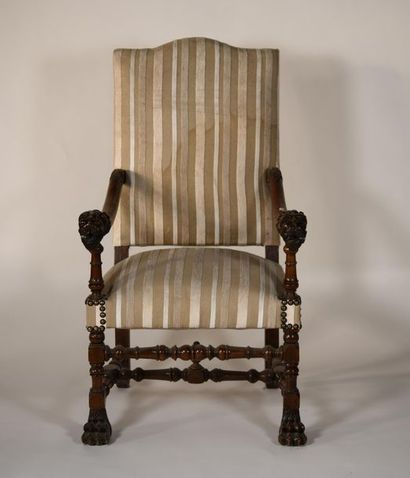 null *Armchair in turned wood, carved lion head armrests. Striped fabric upholstery...