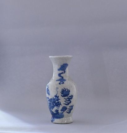 null China, 20th century. Blue white cracked porcelain baluster vase with a dragon...