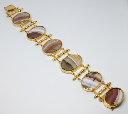 null 
Cuff bracelet composed of six ribbon agate cabochons of oval form on a gilded...