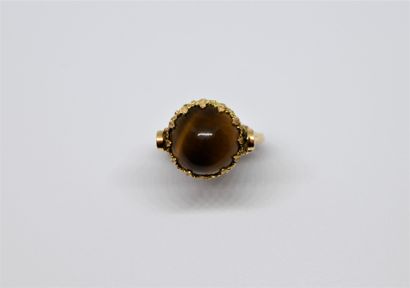 null Reverso ring adorned with a sphere composed of a tiger's eye cabochon on one...