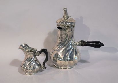 null Silver chocolate and milk pot with twisted ribs, underlined by waves, in the...