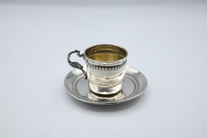 null Silver cup and saucer, with frieze of gadroons and handle with chimera head....
