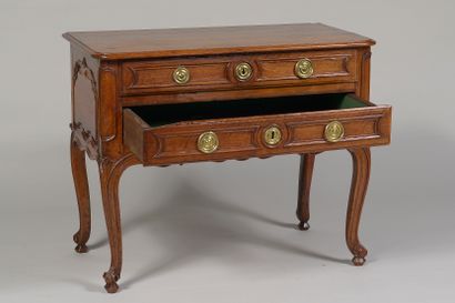 null Man's dressing table 

in walnut molded and carved with volutes. Wooden top,...