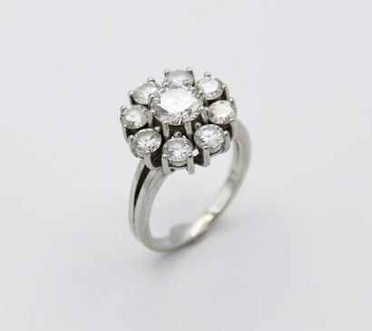 White gold daisy ring centered with a modern-cut...